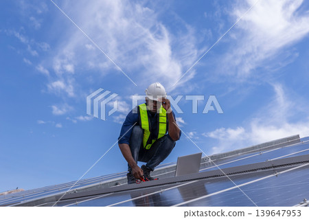 Engineer service check installation solar cell on the roof of factory. Engineer service check installation solar cell on the roof of factory. 139647953