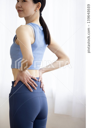 Close-up of a woman's waist in yoga wear. Close-up of a woman's waist in yoga wear. 139648689
