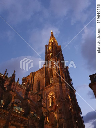 Phone photo of Strasbourg Cathedral at twilight dusk. Dramatic Gothic architecture silhouetted against blue hour sky in a historic European city. Phone photo of Strasbourg Cathedral at twilight dusk. Dramatic Gothic architecture silhouetted against blue hour sky in a historic European city. 139649266