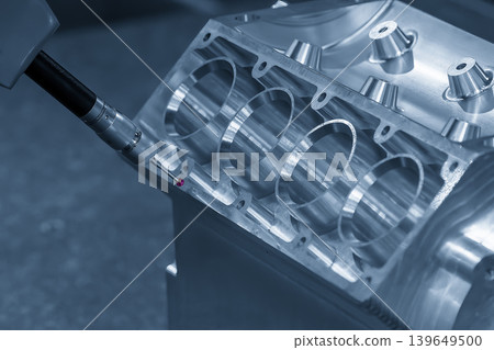 High-precision quality control of a V8 aluminum engine block using a multi-axis CMM (Coordinate Measuring Machine) in a blue-toned scene. High-precision quality control of a V8 aluminum engine block using a multi-axis CMM (Coordinate Measuring Machine) in a blue-toned scene. 139649500