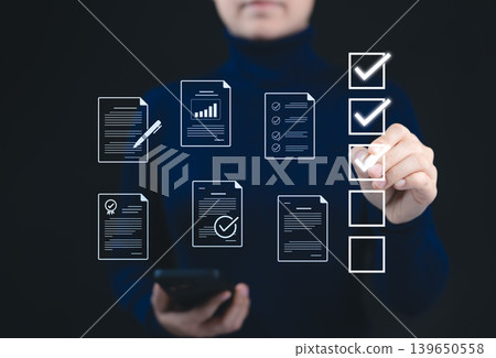 Quality Assurance and Document Control with Checklist Icons. A person marks off items on digital checklist, representing quality assurance and document control processes, verification, and compliance. Quality Assurance and Document Control with Checklist Icons. A person marks off items on digital checklist, representing quality assurance and document control processes, verification, and compliance. 139650558