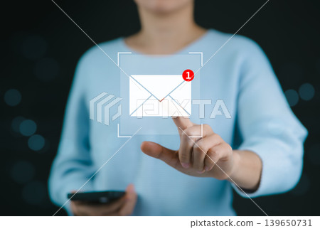 New email notification interaction concept. A woman interacting with a digital interface showing a new email notification symbol, a concept for online communication. E-mail marketing, mail security, 139650731