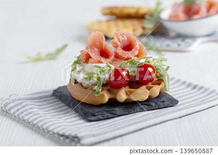 Delicious Belgian waffles with salmon and cream cheese. Delicious Belgian waffles with salmon and cream cheese. 139650887