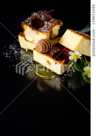 Delicious baked casserole with strawberry filling on black background Delicious baked casserole with strawberry filling on black background 139651049