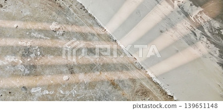 Concrete floor texture with striped fence shadow Concrete floor texture with striped fence shadow 139651148