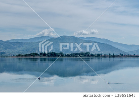 Greece, Kastoria: Reflection of mountains and clouds on Lake Orestiada Greece, Kastoria: Reflection of mountains and clouds on Lake Orestiada 139651645