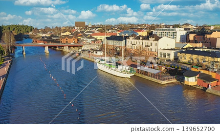 Porvoo, Finland - December 08, 2020: Scenic view of a river with boats, surrounded by colorful buildings and a clear blue sky, showcasing a vibrant urban landscape Porvoo, Finland - December 08, 2020: Scenic view of a river with boats, surrounded by colorful buildings and a clear blue sky, showcasing a vibrant urban landscape 139652700