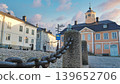 Porvoo, Finland - December 08, 2020: Historic architecture featuring cobblestone street, decorative chain, and colorful buildings, creating a charming urban atmosphere 139652706