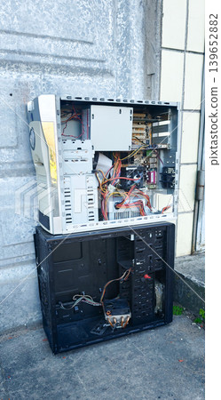 Old computer tower and components left outside in a city area near a building Old computer tower and components left outside in a city area near a building 139652882