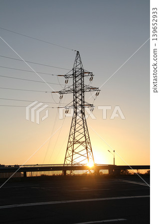 Power Tower on a Highway with Metal Railings at Sunset Power Tower on a Highway with Metal Railings at Sunset 139652933