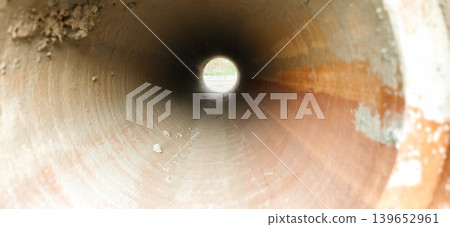 Construction of concrete pipes inside a work site during daylight hours Construction of concrete pipes inside a work site during daylight hours 139652961