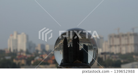 Miniature skyscrapers inside a souvenir crystal ball with reflection of a real cityscape inside Miniature skyscrapers inside a souvenir crystal ball with reflection of a real cityscape inside 139652988