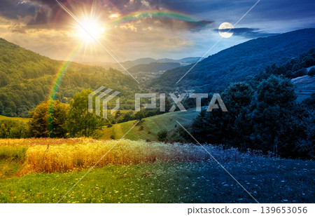 rural field on the hill. time change concept. view in to the valley at twilight. sun and moon over countryside mountain landscape. alpine pasture near forested hills. uncertainty and trust issues rural field on the hill. time change concept. view in to the valley at twilight. sun and moon over countryside mountain landscape. alpine pasture near forested hills. uncertainty and trust issues 139653056