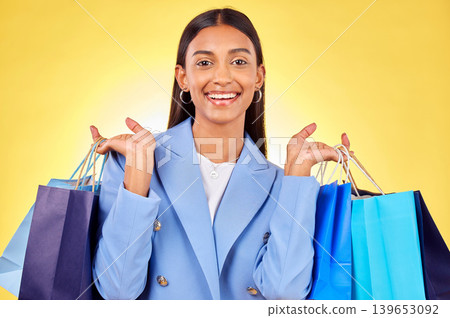 Business woman, shopping bag and studio portrait with smile, success or deal by yellow background. Happy customer experience, gift and discount with retail therapy, sale or excited for fashion choice Business woman, shopping bag and studio portrait with smile, success or deal by yellow background. Happy customer experience, gift and discount with retail therapy, sale or excited for fashion choice 139653092