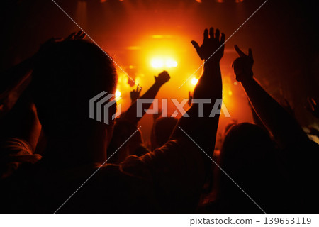 Club, concert and audience with hands or lights for music, party and rave festival with silhouette and dancing. Disco, psychedelic event or performance with entertainment, crowd and rear view gesture Club, concert and audience with hands or lights for music, party and rave festival with silhouette and dancing. Disco, psychedelic event or performance with entertainment, crowd and rear view gesture 139653119