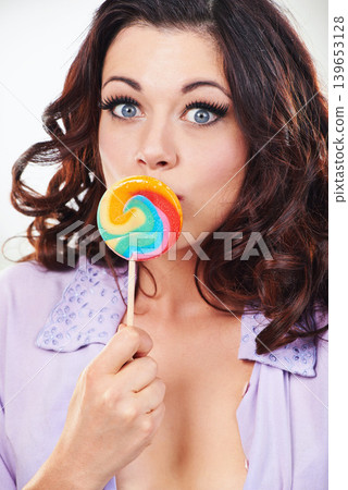 Portrait, model and candy lollipop in studio by sugar food and happiness for sweets in mouth. Young woman, french and face for hungry with color dessert, eating snack and smile by white background Portrait, model and candy lollipop in studio by sugar food and happiness for sweets in mouth. Young woman, french and face for hungry with color dessert, eating snack and smile by white background 139653128
