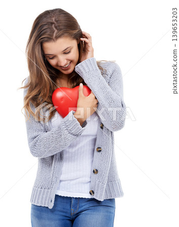 Red heart, smile and shy woman in studio for love, care and romance, affection or support on white background. Shape, flirt and female model with symbol, sign or icon for valentines day celebration Red heart, smile and shy woman in studio for love, care and romance, affection or support on white background. Shape, flirt and female model with symbol, sign or icon for valentines day celebration 139653203