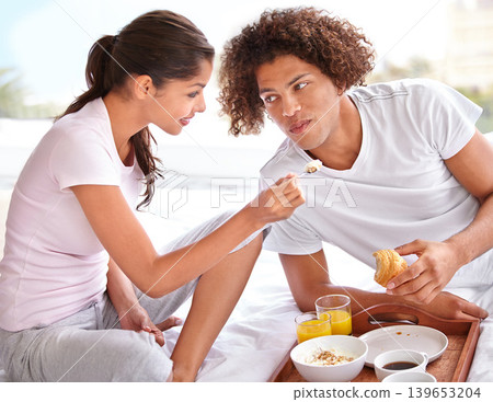 Couple, feeding and breakfast in bed for bonding, healthy meal and celebrating anniversary at home. People, marriage milestone and love or loyalty in relationship, romance and food for nutrition Couple, feeding and breakfast in bed for bonding, healthy meal and celebrating anniversary at home. People, marriage milestone and love or loyalty in relationship, romance and food for nutrition 139653204