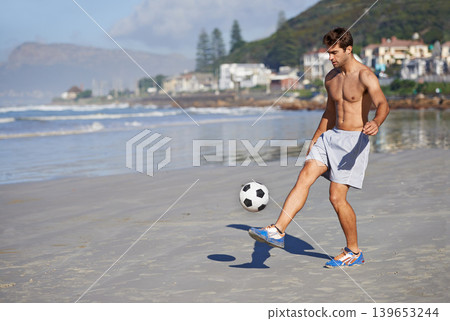 Man, beach and playing with soccer ball for game, sports or exercise in outdoor hobby, training or practice. Young male person or football player on ocean coast for match or cardio workout by seaside Man, beach and playing with soccer ball for game, sports or exercise in outdoor hobby, training or practice. Young male person or football player on ocean coast for match or cardio workout by seaside 139653244