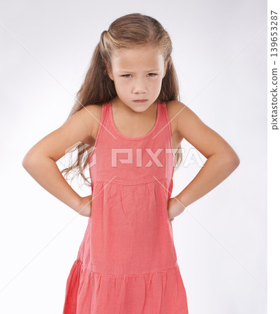 Portrait, unhappy or tantrum and girl child in studio on white background with anger and frustration. Cross, problem or moody and young kid with bad attitude looking upset at problem or mistake Portrait, unhappy or tantrum and girl child in studio on white background with anger and frustration. Cross, problem or moody and young kid with bad attitude looking upset at problem or mistake 139653287