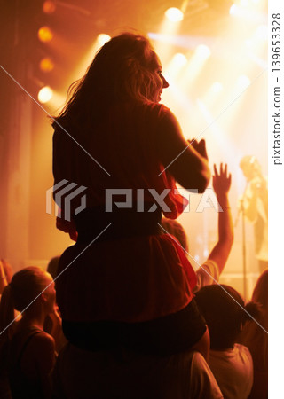 Concert, woman and friends at festival with piggyback for party, nightclub and dancing with spotlight and lights. Disco, psychedelic event and performance with entertainment, crowd and rear view Concert, woman and friends at festival with piggyback for party, nightclub and dancing with spotlight and lights. Disco, psychedelic event and performance with entertainment, crowd and rear view 139653328