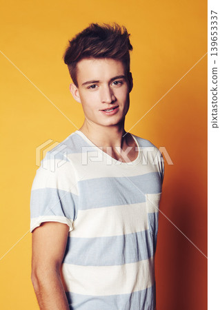 Portrait, fashion and man with style, trendy and confident guy on an orange studio background. Face, person and model with casual outfit, sexy and stylish clothes with gen z, t shirt and aesthetic Portrait, fashion and man with style, trendy and confident guy on an orange studio background. Face, person and model with casual outfit, sexy and stylish clothes with gen z, t shirt and aesthetic 139653337