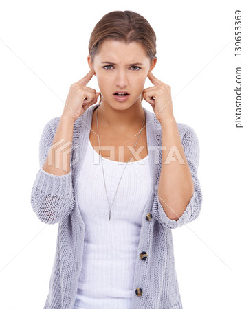 Noise, portrait or woman with fingers in ears in studio for volume control, sensitive or block on white background. Annoyed, stop or model with not listening gesture, sound or frustrated by tinnitus Noise, portrait or woman with fingers in ears in studio for volume control, sensitive or block on white background. Annoyed, stop or model with not listening gesture, sound or frustrated by tinnitus 139653369
