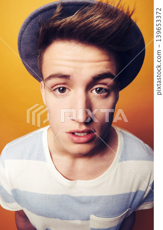 Portrait, hat and man with fashion, stylish clothes and confident guy on an orange studio background. Face, person and model with accessory, student and aesthetic with casual outfit, trendy and cool Portrait, hat and man with fashion, stylish clothes and confident guy on an orange studio background. Face, person and model with accessory, student and aesthetic with casual outfit, trendy and cool 139653372