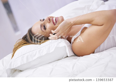 Happy woman, phone call and laughing on bed for funny joke, communication or discussion at home. Female person smile, lying and talking in bedroom on mobile smartphone for fun conversation or humor Happy woman, phone call and laughing on bed for funny joke, communication or discussion at home. Female person smile, lying and talking in bedroom on mobile smartphone for fun conversation or humor 139653387