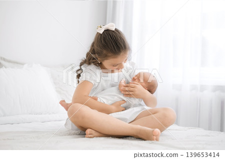 A crying, screaming newborn baby in his sister's arms. The first meeting with my brother A crying, screaming newborn baby in his sister's arms. The first meeting with my brother 139653414