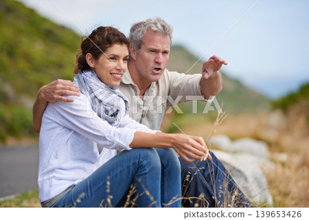 Mature, couple and pointing at nature on holiday, vacation or embrace with love or support in marriage. Happy, woman and man together sightseeing on hill, mountain or relax in environment adventure Mature, couple and pointing at nature on holiday, vacation or embrace with love or support in marriage. Happy, woman and man together sightseeing on hill, mountain or relax in environment adventure 139653426