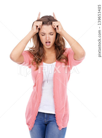 Woman, playful and devil horns in studio, bully and naughty gesture for attitude on white background. Female person, bad girl and fingers for emoji, bull and comedy or humor on isolated backdrop Woman, playful and devil horns in studio, bully and naughty gesture for attitude on white background. Female person, bad girl and fingers for emoji, bull and comedy or humor on isolated backdrop 139653485