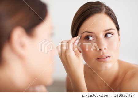Beauty, mirror and woman with tweezers for eyebrow maintenance, hair removal or cosmetic treatment. Home bathroom, morning self care or person with mirror, microblading and plucking for face grooming Beauty, mirror and woman with tweezers for eyebrow maintenance, hair removal or cosmetic treatment. Home bathroom, morning self care or person with mirror, microblading and plucking for face grooming 139653487