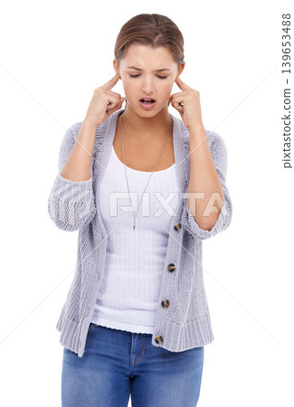 Noise, loud or woman with fingers in ears in studio for volume control, sensitive or block on white background. Annoyed, stop or lady model with not listening gesture, sound or frustrated by tinnitus Noise, loud or woman with fingers in ears in studio for volume control, sensitive or block on white background. Annoyed, stop or lady model with not listening gesture, sound or frustrated by tinnitus 139653488