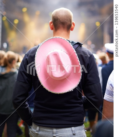 Man, crowd and music festival event audience or cowboy hat, rave outfit at party concert. Male person, back view and dj dancing night a social vacation for holiday relax experience, band to celebrate Man, crowd and music festival event audience or cowboy hat, rave outfit at party concert. Male person, back view and dj dancing night a social vacation for holiday relax experience, band to celebrate 139653540
