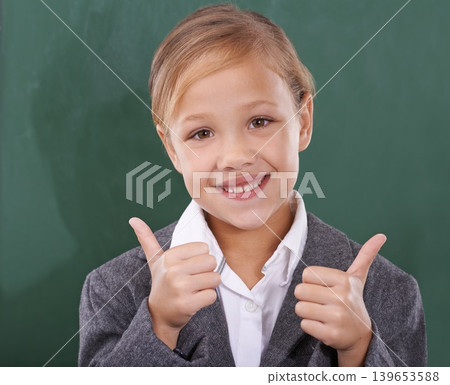 Child by chalkboard, portrait and thumbs up for education, learning and school success, like and support. Face of happy kid, girl or student with good job, yes or ok hands for classroom achievement 139653588