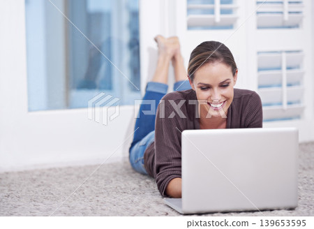 Woman, remote work and laptop to relax on floor, update blog post and digital news on social media at home. Happy freelancer, computer or download subscription, online shopping or streaming on ground Woman, remote work and laptop to relax on floor, update blog post and digital news on social media at home. Happy freelancer, computer or download subscription, online shopping or streaming on ground 139653595