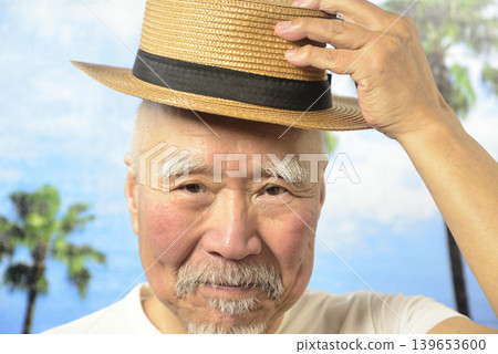 A smiling old man with a beard under a blue sky 139653600