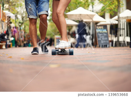 People, skateboarding and outdoor in city, legs and teaching to ride together for romantic relationship. Cape town, fun and hobby with boyfriend and girlfriend in street, helping and playful date People, skateboarding and outdoor in city, legs and teaching to ride together for romantic relationship. Cape town, fun and hobby with boyfriend and girlfriend in street, helping and playful date 139653668