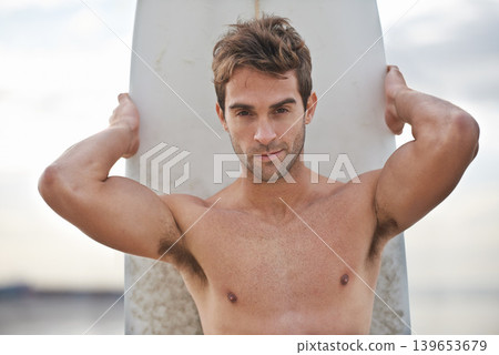 Young man, portrait and surfboard on beach for fitness, waves or exercise in outdoor hobby, surfing or practice. Active male person or surfer with board for training, seaside or ocean coast in nature Young man, portrait and surfboard on beach for fitness, waves or exercise in outdoor hobby, surfing or practice. Active male person or surfer with board for training, seaside or ocean coast in nature 139653679