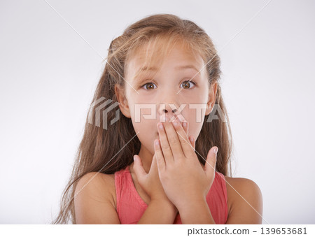Child, portrait and hand or mouth for shock information or surprise news for announcement, omg or white background. Female person, face and gesture in studio for gossip emoji, wow or mockup space Child, portrait and hand or mouth for shock information or surprise news for announcement, omg or white background. Female person, face and gesture in studio for gossip emoji, wow or mockup space 139653681