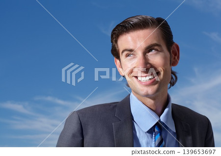Face, smile and vision with a business man on a blue sky background, thinking about the future. Corporate, idea and a happy young professional employee outdoor in a suit for company planning Face, smile and vision with a business man on a blue sky background, thinking about the future. Corporate, idea and a happy young professional employee outdoor in a suit for company planning 139653697
