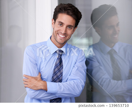 Window, crossed arms and portrait of businessman in workplace with confidence, pride and ambition. Corporate entrepreneur, professional and happy worker for career, job and working in modern office 139653710