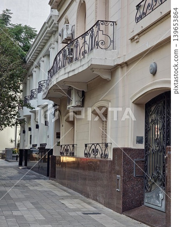 The rays of the setting Argentine sun paint the white buildings yellow. A building on Chaca Buca Boulevard in Cordoba The rays of the setting Argentine sun paint the white buildings yellow. A building on Chaca Buca Boulevard in Cordoba 139653864