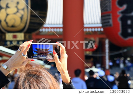 Taking photos of the large lantern in Asakusa; foreign tourists sightseeing in Asakusa. Taking photos of the large lantern in Asakusa; foreign tourists sightseeing in Asakusa. 139653953