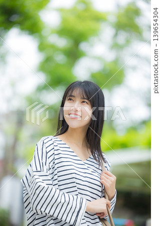 A woman walking outdoors 139654304