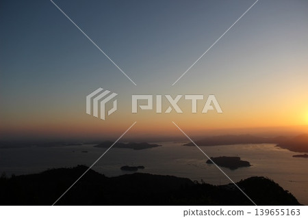 The beautiful archipelago of the Seto Inland Sea and the city as seen from the Misen Observatory on Miyajima Island in Hatsukaichi City, Hiroshima Prefecture, bathed in the morning sun. The beautiful archipelago of the Seto Inland Sea and the city as seen from the Misen Observatory on Miyajima Island in Hatsukaichi City, Hiroshima Prefecture, bathed in the morning sun. 139655163