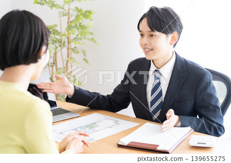 A young real estate salesman and a client A young real estate salesman and a client 139655275