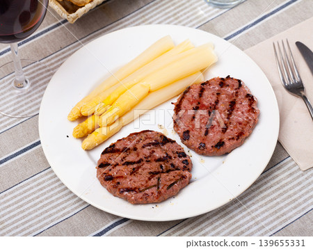 Grilled cutlets dish with boiled asparagus Grilled cutlets dish with boiled asparagus 139655331