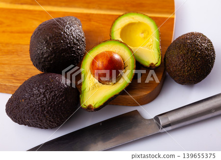 Closeup of whole fresh green avocado on wooden Closeup of whole fresh green avocado on wooden 139655375